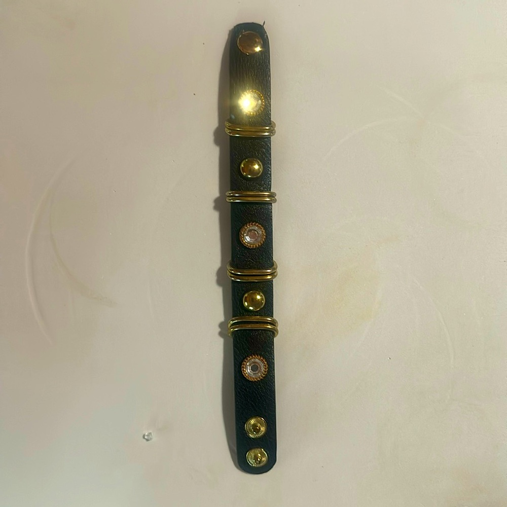 Black leather bracelet with gold rings, rhinestones or cubic zirconia with snaps